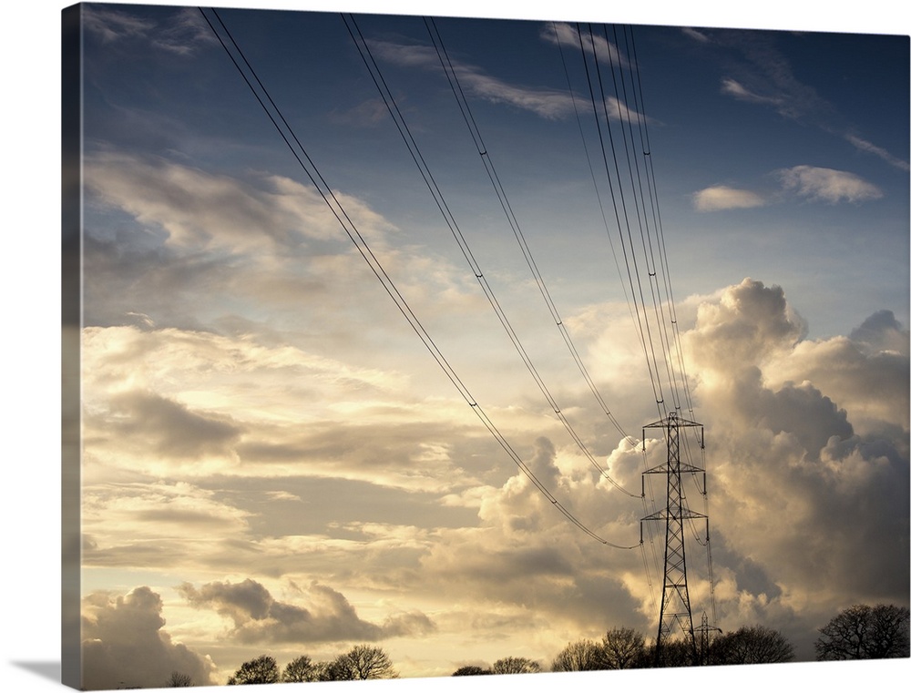 Electric high power lines against beautiful cloud formation.