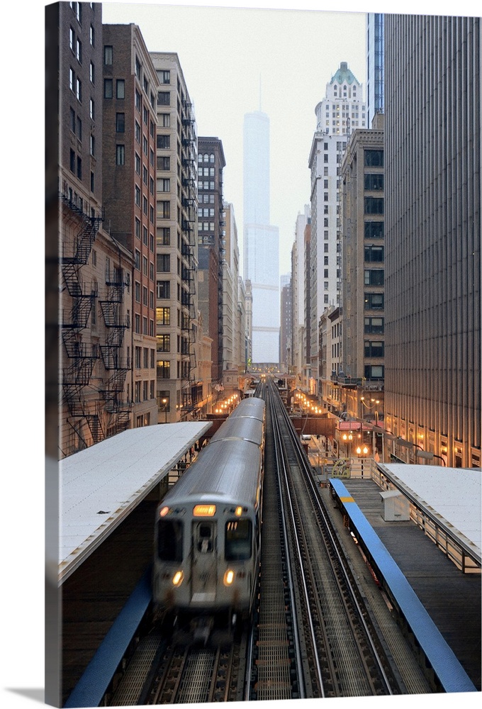 Vertical panoramic photograph of railway lined with tall buildings and skyscrapers.