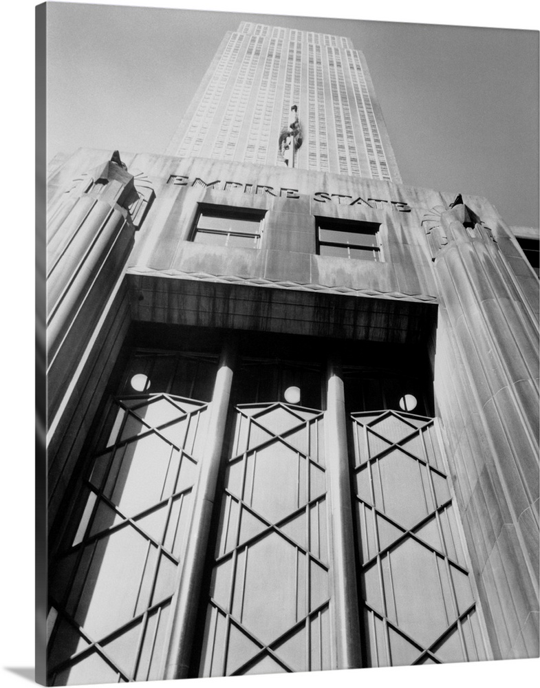 Empire State Building in New York City as seen from the sidewalk looking up.