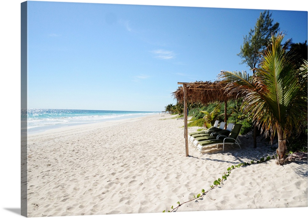 Empty beach chairs on a white sand beach