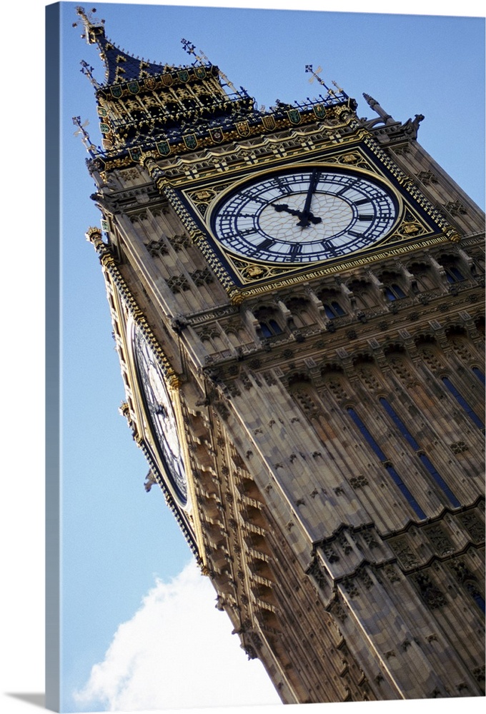 Big Ben is photographed from below showing mostly the top of the structure at an angle.
