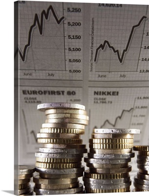 Euro Currency: Unevenly stacked coins, financial graphs in background