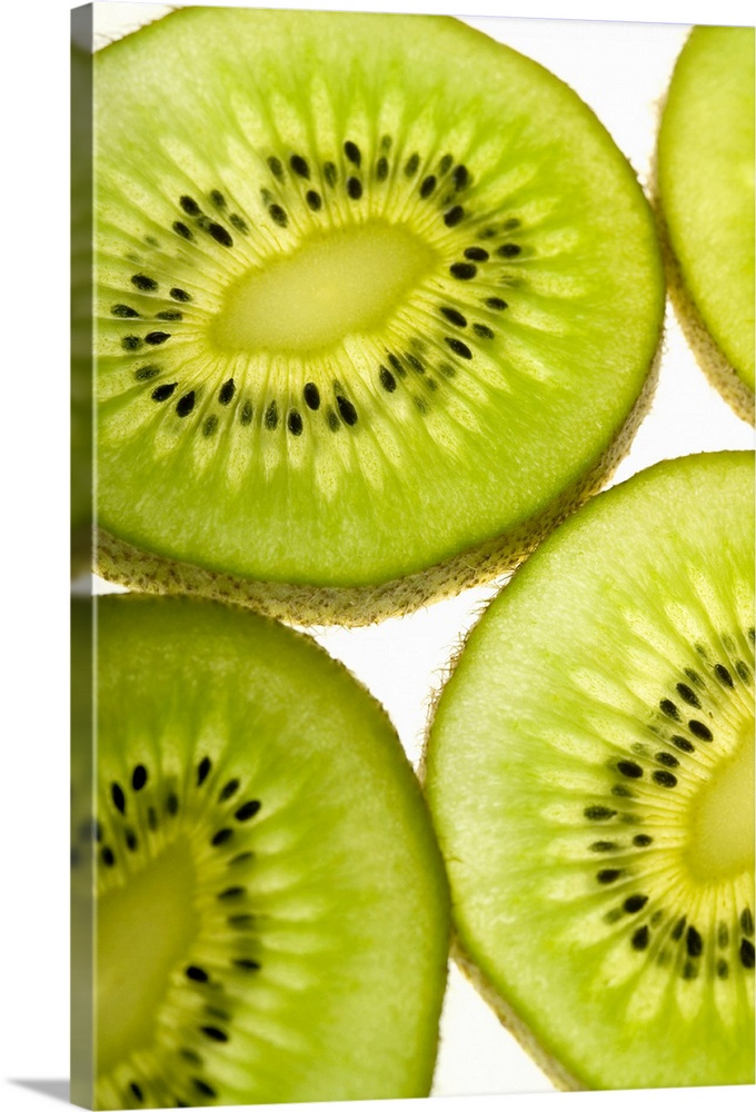 Extreme close-up of four pieces of sliced kiwi fruit, part of
