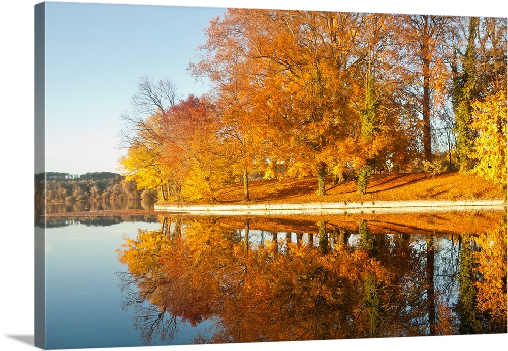 Autumn colored trees mirroring them self in river.