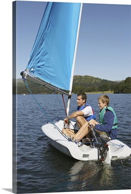 Father and son on small sailboat