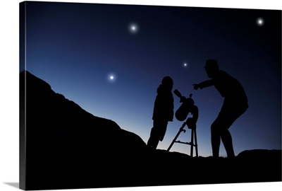 Father and Young Boy (6 years old) outside at night stargazing with a telescope.