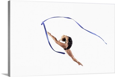 Female Athlete Jumping Gracefully Mid Air With a Ribbon