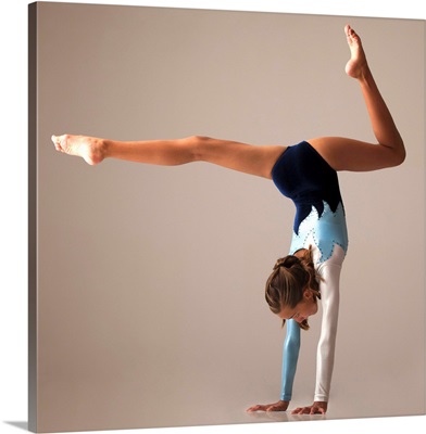 Female gymnast performing handstand