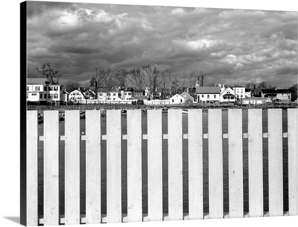 Overcast skies and a board fence frame the small town of Stonington, Connecticut.