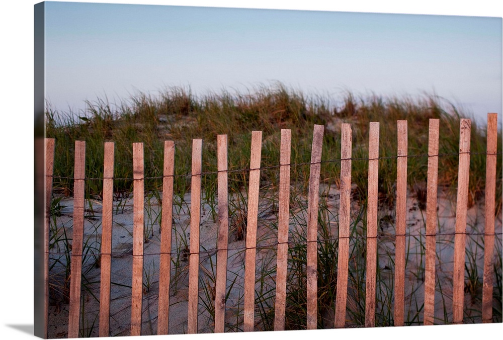 USA, Massachusetts, Barnstable, Fence along Cape Cod sand dunes at sunset on summer evening