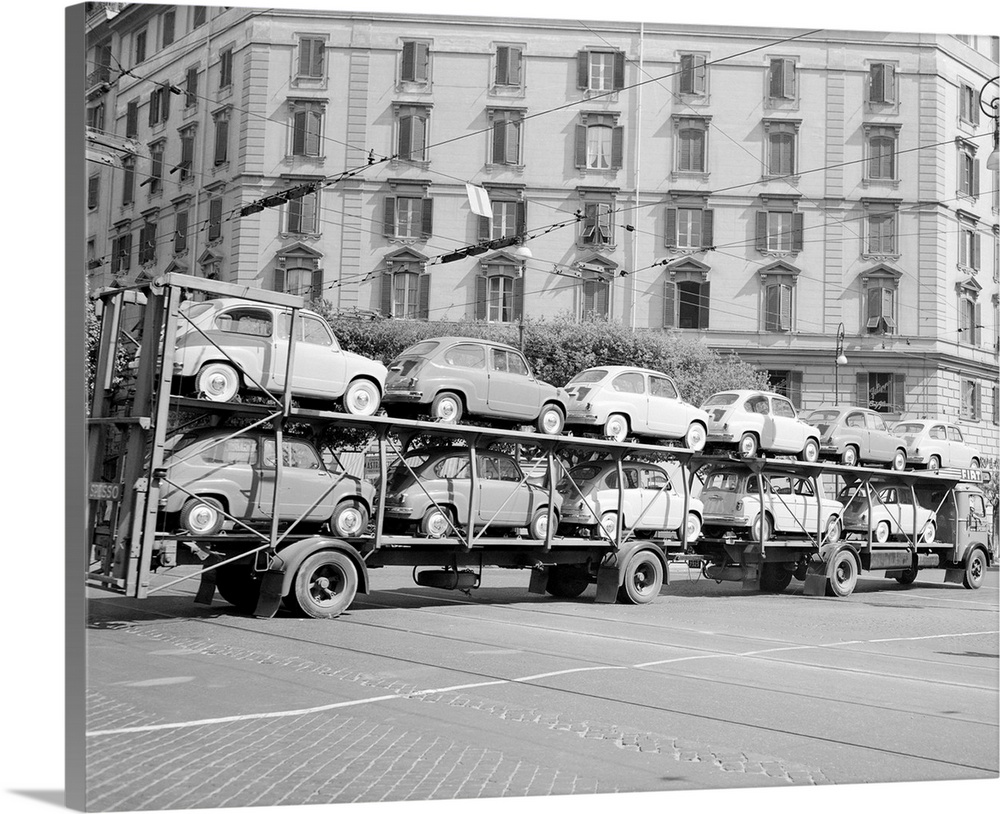 The Italian auto industry is rolling along at a good pace, as evidenced by this double trailer load of new baby Fiat 600 c...