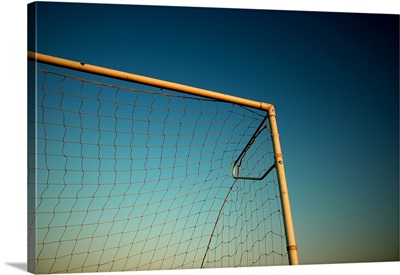 Football (Soccer) Goalpost and net against blue sky.