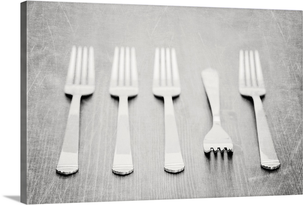 Forks on tabletop, black and white textured image.