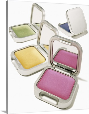 Four brightly colored eyeshadows in metallic cases