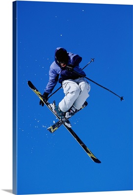Free skier in mid-air jump, low angle view