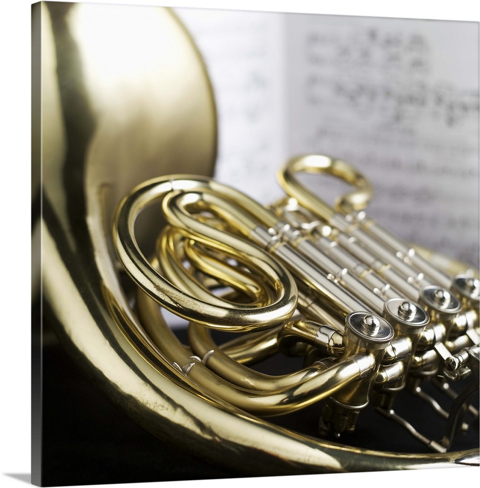 French horn in front of sheet music
