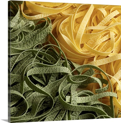 Fresh dry fettuccini pasta in green and yellow