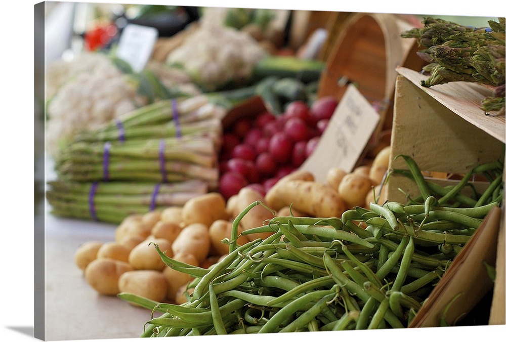 Vegetables for sale on a table at an outdoor market.