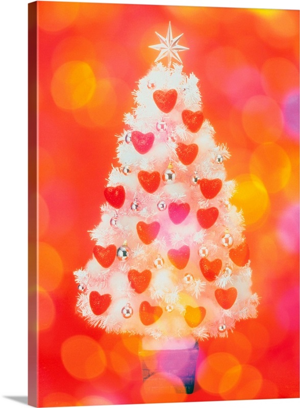 Frosted Christmas tree decorated with heart shaped ornaments, front