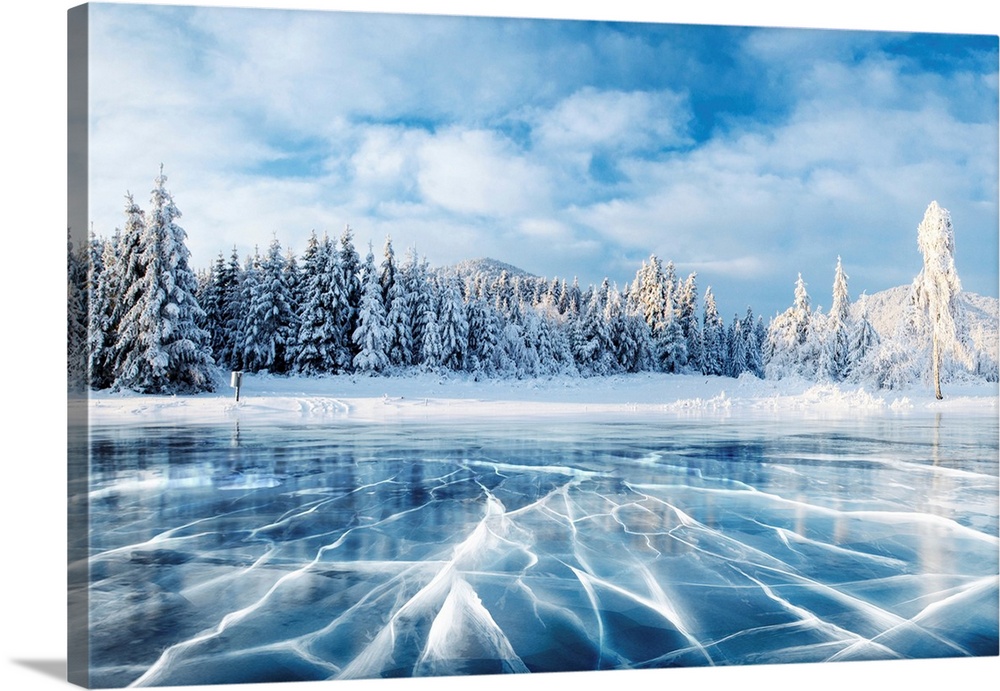 Blue ice and cracks on a frozen lake under a blue sky in the winter in Carpathian, Ukraine.