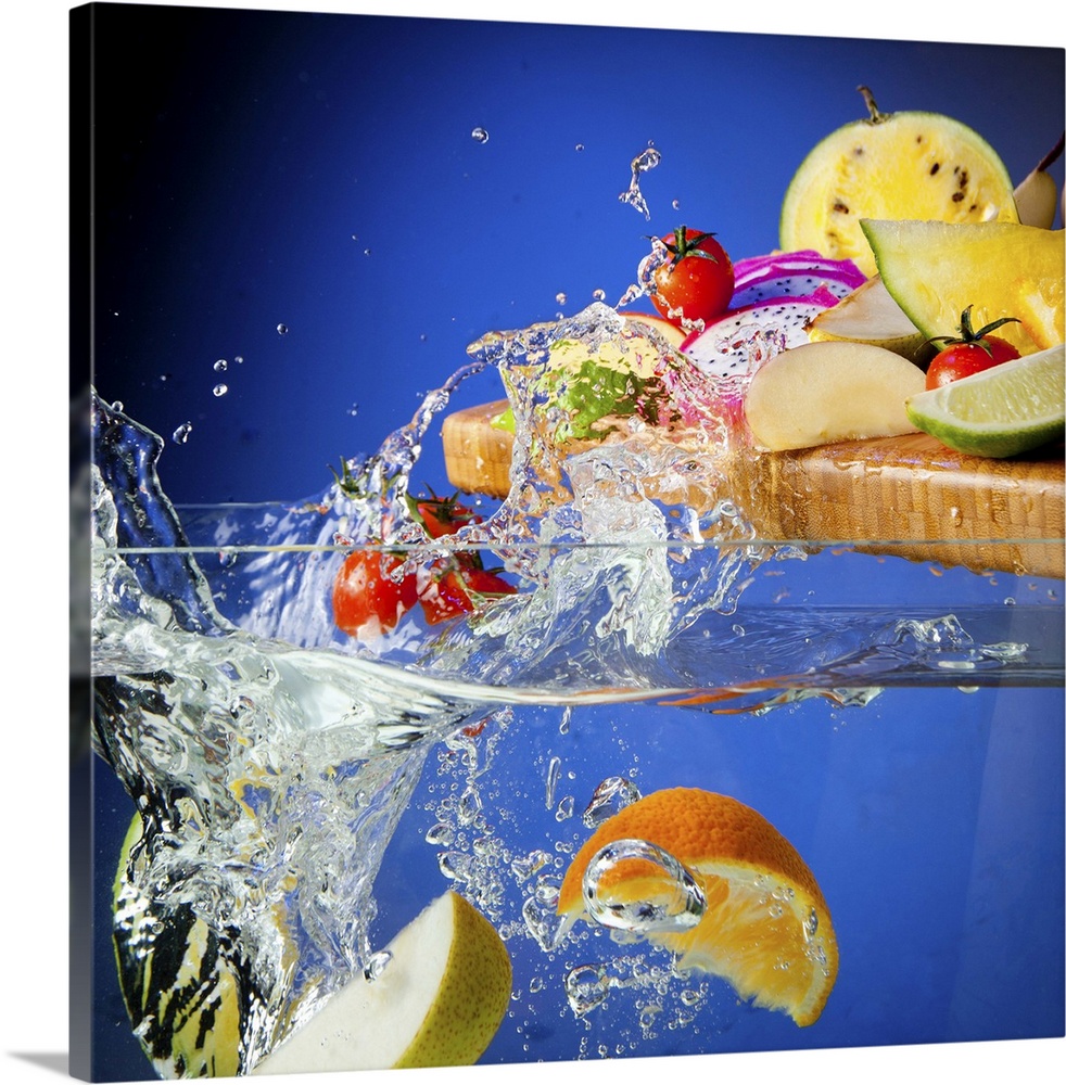 Fresh assorted Fruits on a chopping board splashing in a tank of water