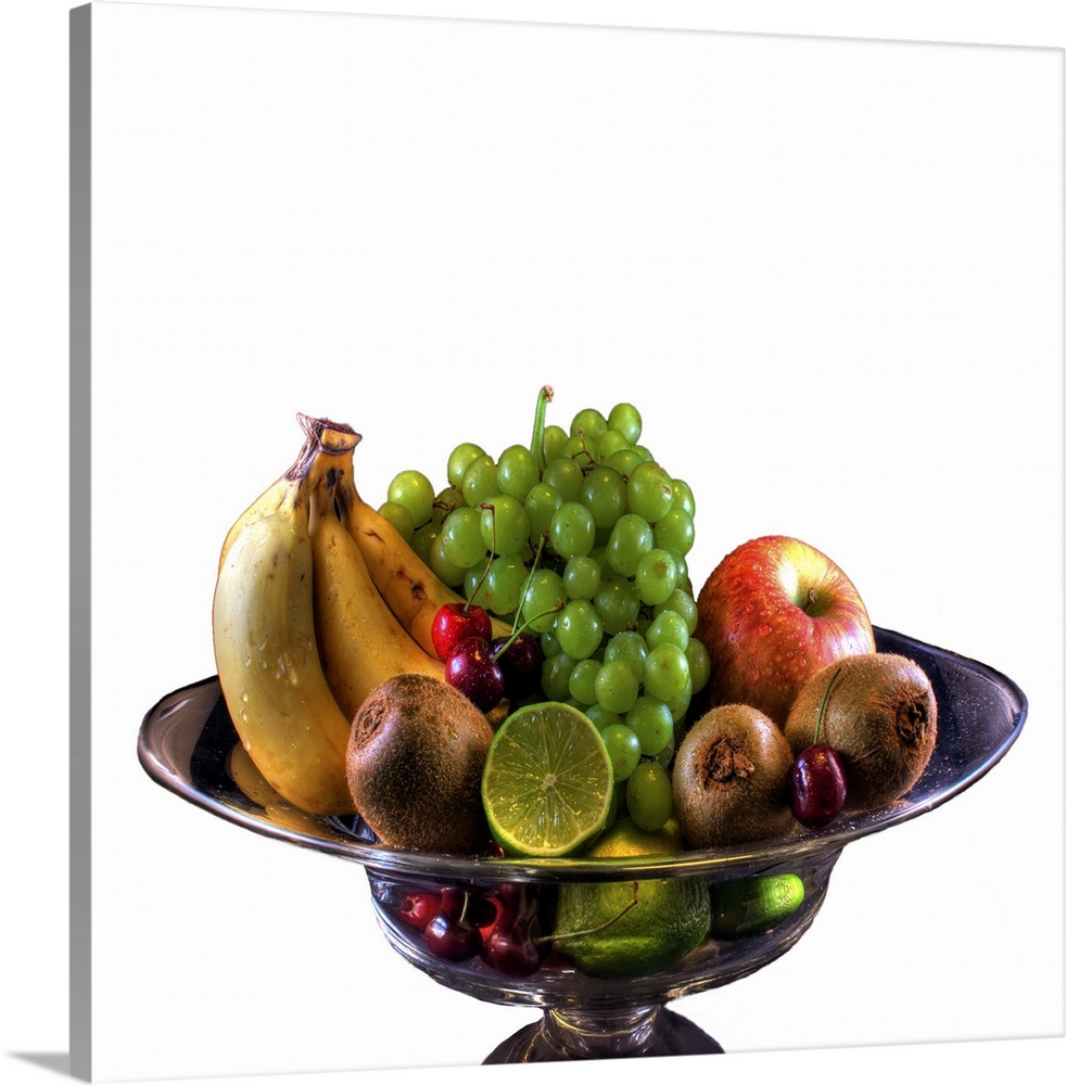 Banana, apple, cherries, kiwi, lime and grapes kept in bowl on white background.