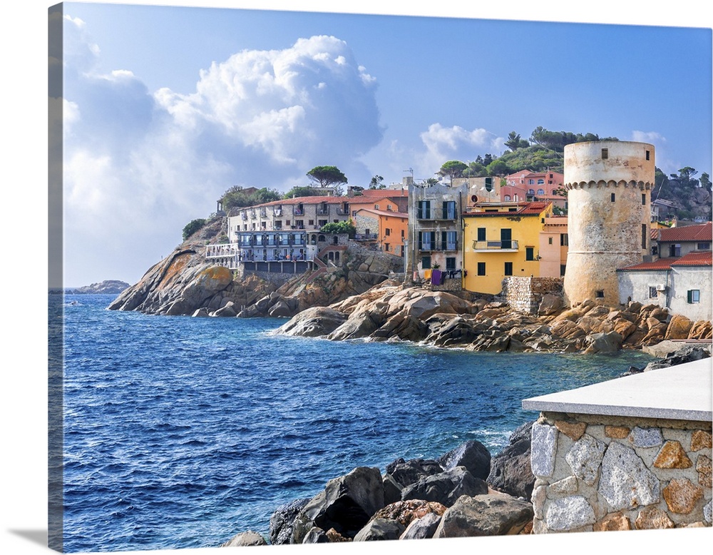 The perfect tiny seaside village of "Giglio Porto" with multi colored houses, an ancient defensive tower and a rocky coast...