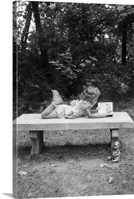 Girl Reading On Bench