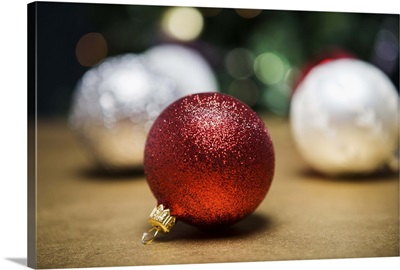 Glitter baubles in front of Christmas tree