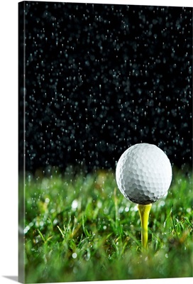 Golf ball on tee in rain