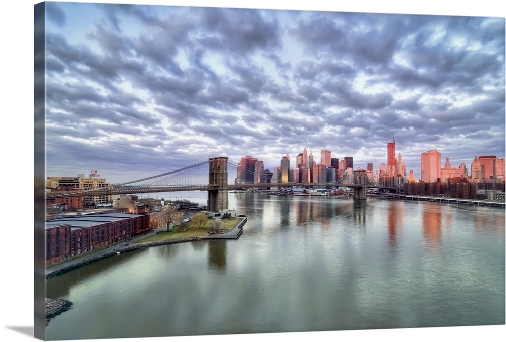 Gorgeous morning view and city reflections from the Manhattan Bridge looking toward the Brooklyn Bridge and downtown New Y...
