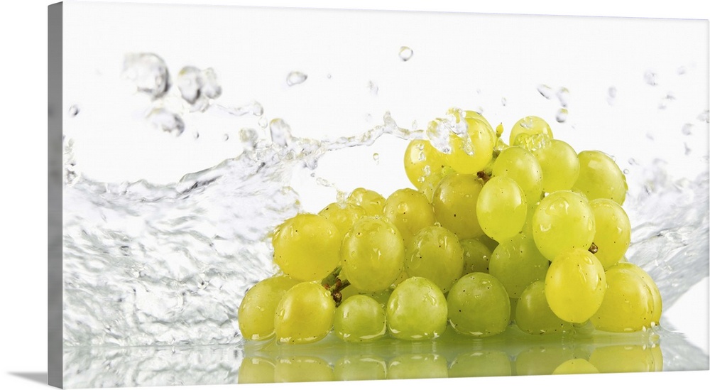 Green grapes being washed in water
