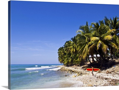 Haiti, Caribbean Sea, man with surfboard.