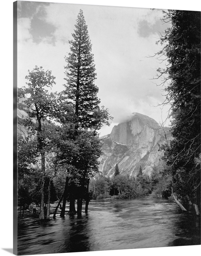 Half Dome, one of Yosemite Park's most familiar landmarks, rises beyond the Merced River.