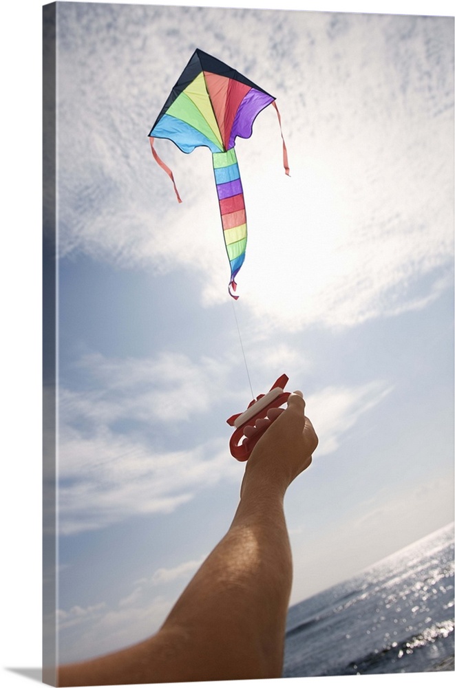 Hand holding string of flying kite