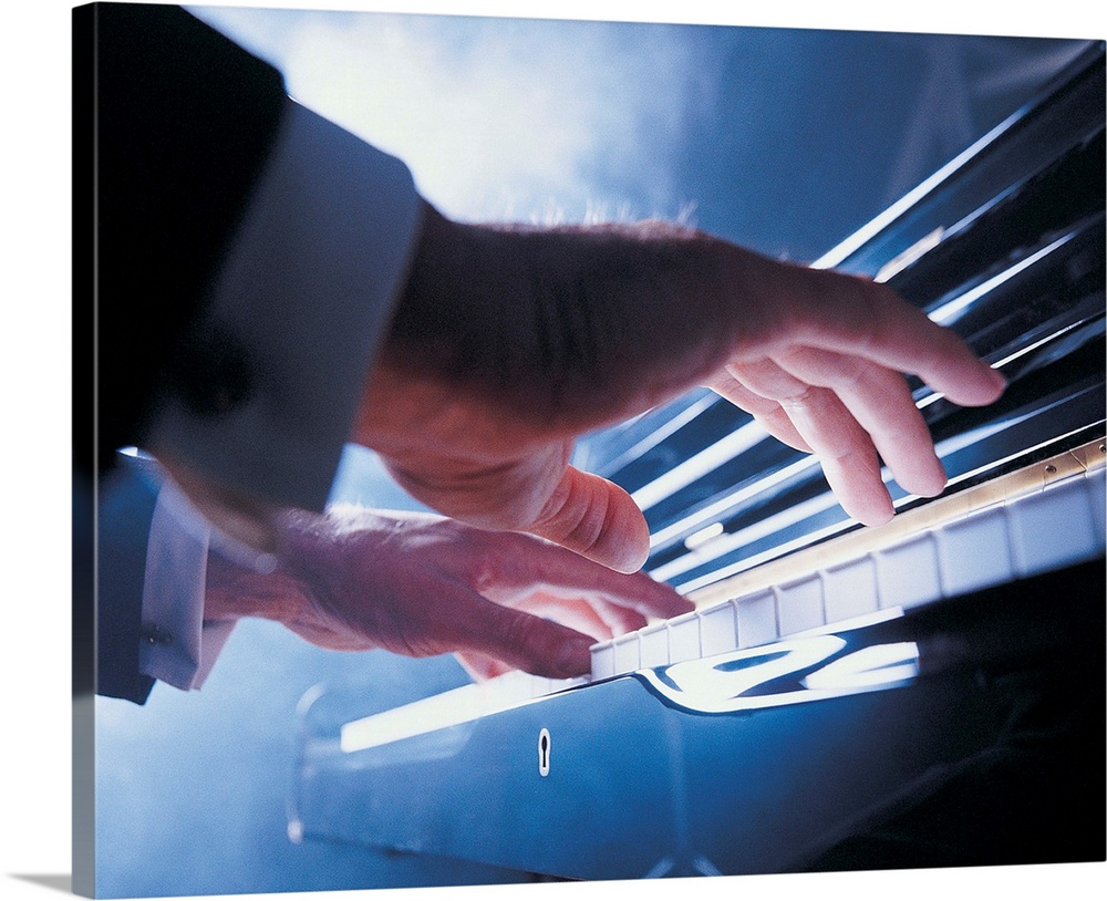 Hands playing piano keys