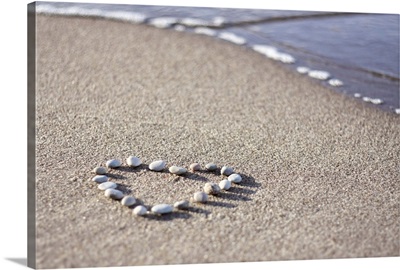 Heart made of pebbles on sand, Poland.