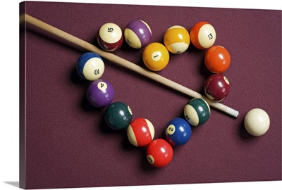 Heart shaped billiard balls with cue ball and stick