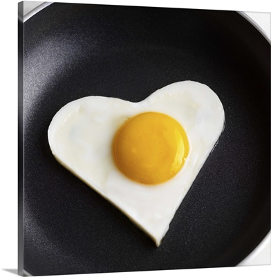Heart-shaped fried egg in skillet