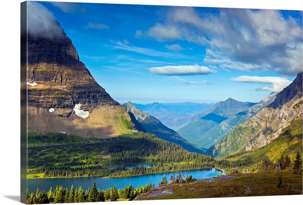 Large, landscape photograph of  Hidden Lake from an overlook, surrounded by mountains in Glacier National Park.