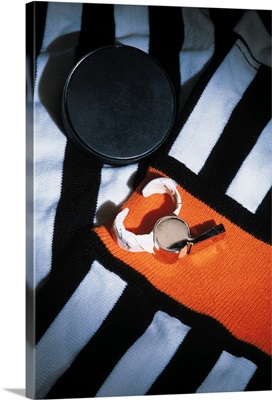 Hockey referee's uniform , whistle and hockey puck