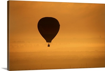 Hot air balloon flying at dusk