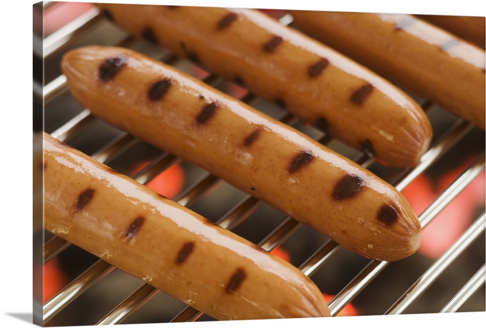 Hot dogs cooking on grill