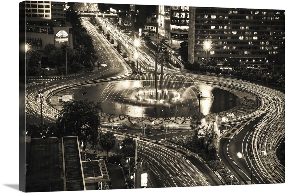 Hotel Indonesia Roundabout and fountains, new design of pool, and lighting at night in Jakarta, Indonesia.