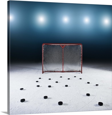 Ice hockey goal surrounded by pucks
