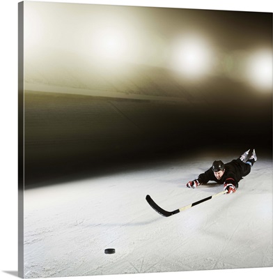 Ice hockey player diving for puck