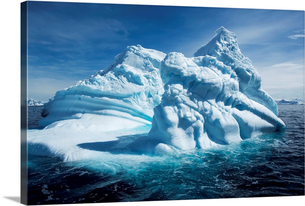 Antarctica, Iceberg floating near mountainous coast by Gerlache Strait along Antarctic Peninsula
