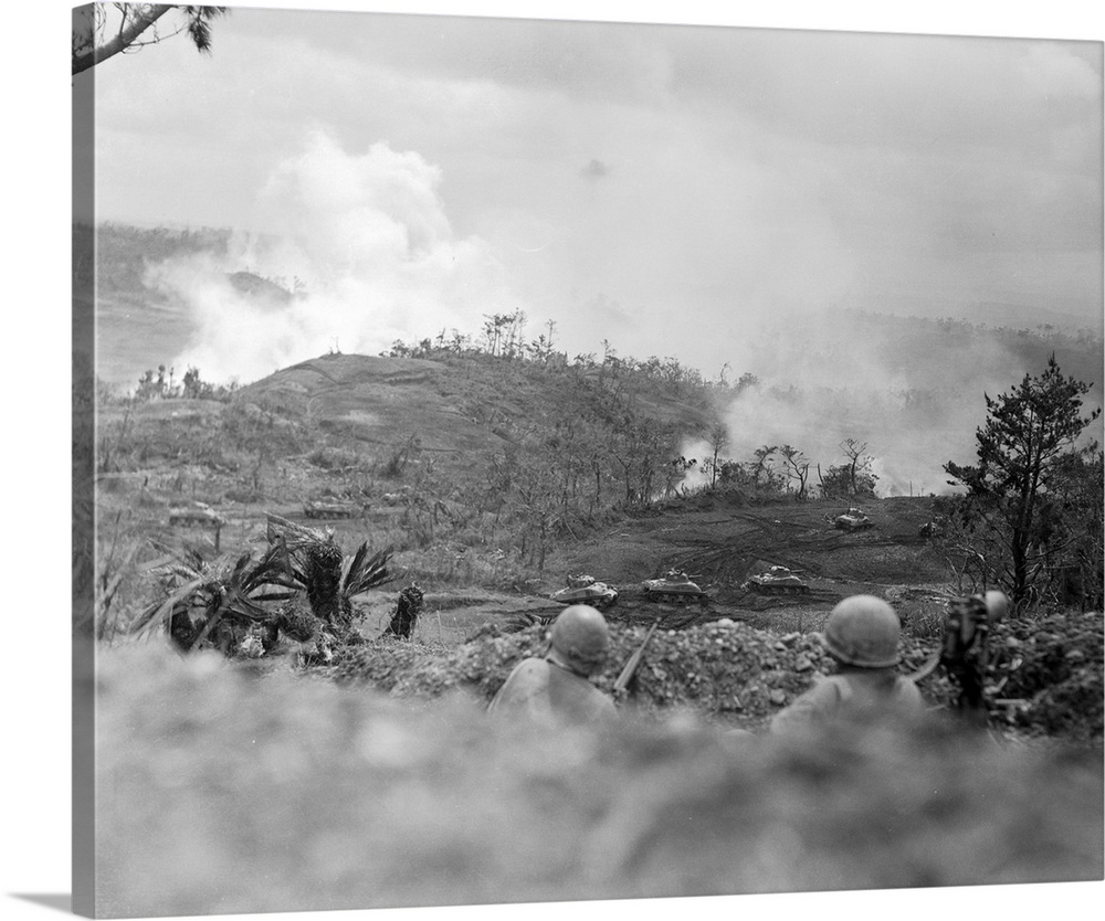 This photo shows infantrymen as they watch from a trench in foreground, as American tanks of the American invasion forces ...