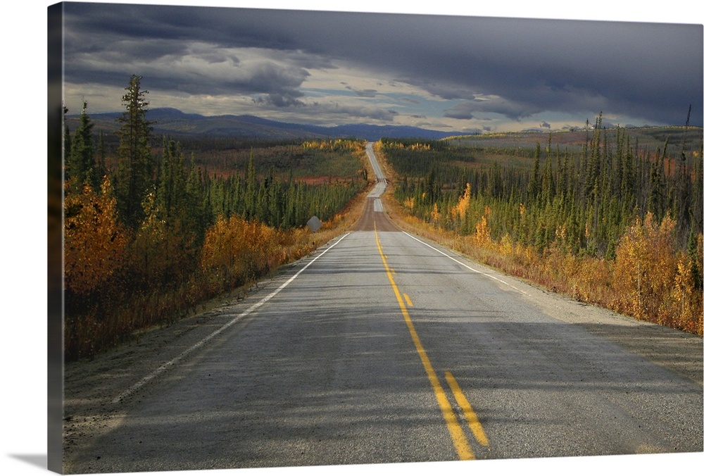 Taylor highway, south of Chicken, Alaska.  The highway is paved in parts, gravel in others, potholed and bumpy most of the...