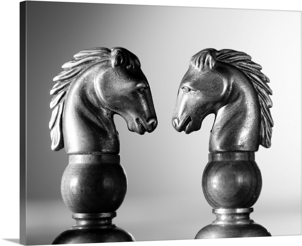 Two chess knights facing off.  Profile shots of two horses in a chess game.
